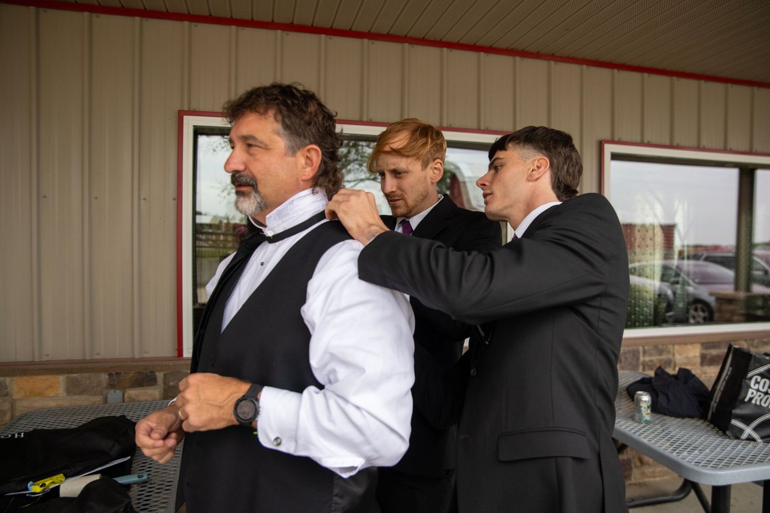 Wedding party members sharing drinks and toasting during celebration.