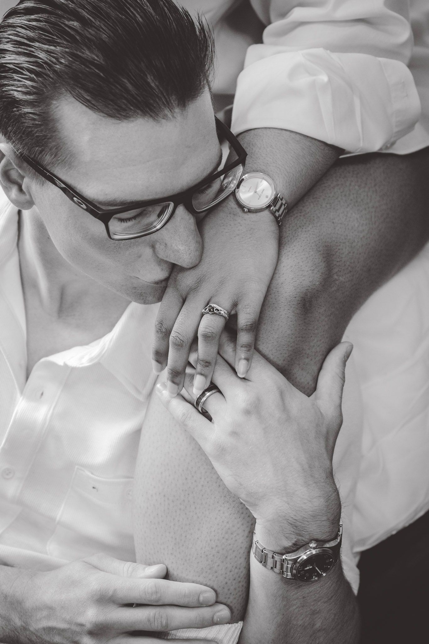 Artistic black and white close-up shots showing tender moments against white clothing.