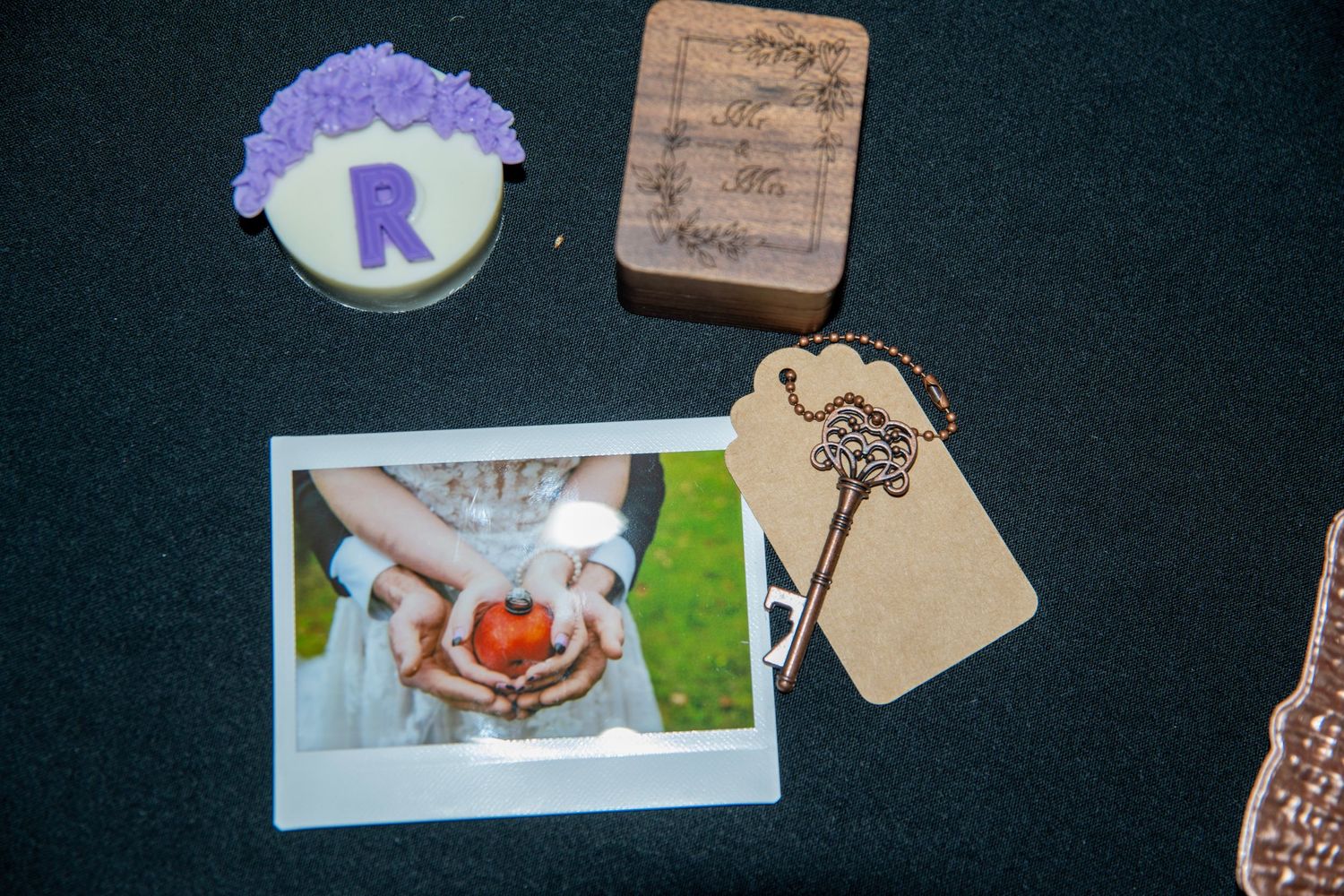 Wedding planning materials and decorative elements arranged on dark background.