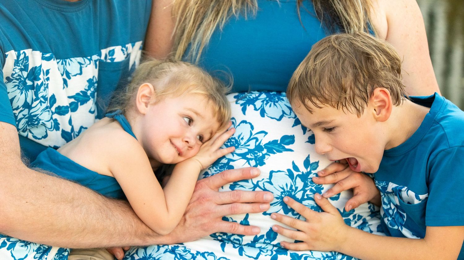 Playful outdoor photo sequence showing family interaction in coordinating blue outfits.