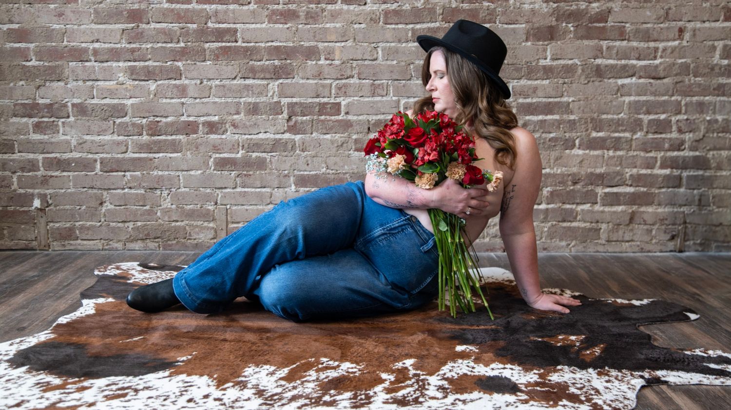Artistic photo sequence showing someone lying on a wooden table with red roses against a brick wall background.