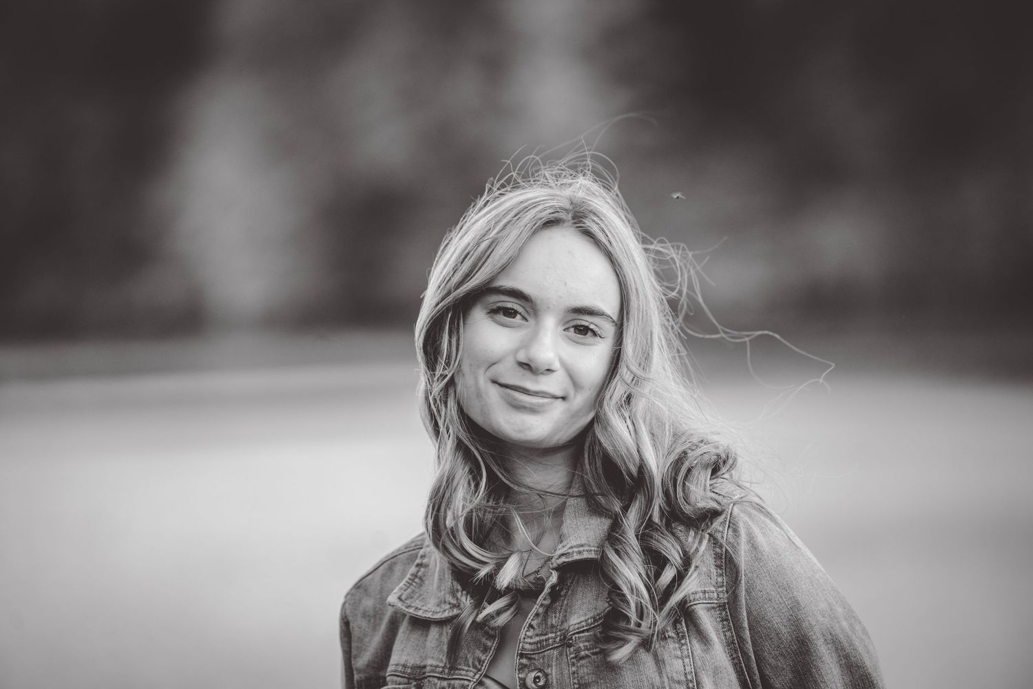 Black and white portrait series capturing natural expressions against a soft blurred background.