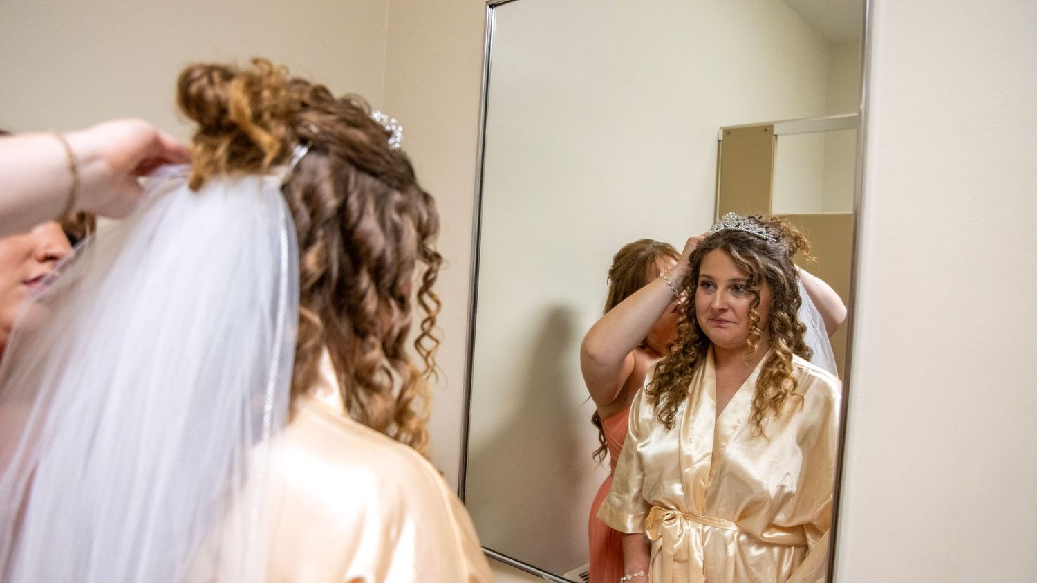 Wedding preparation scene with formal attire reflected in mirrors.