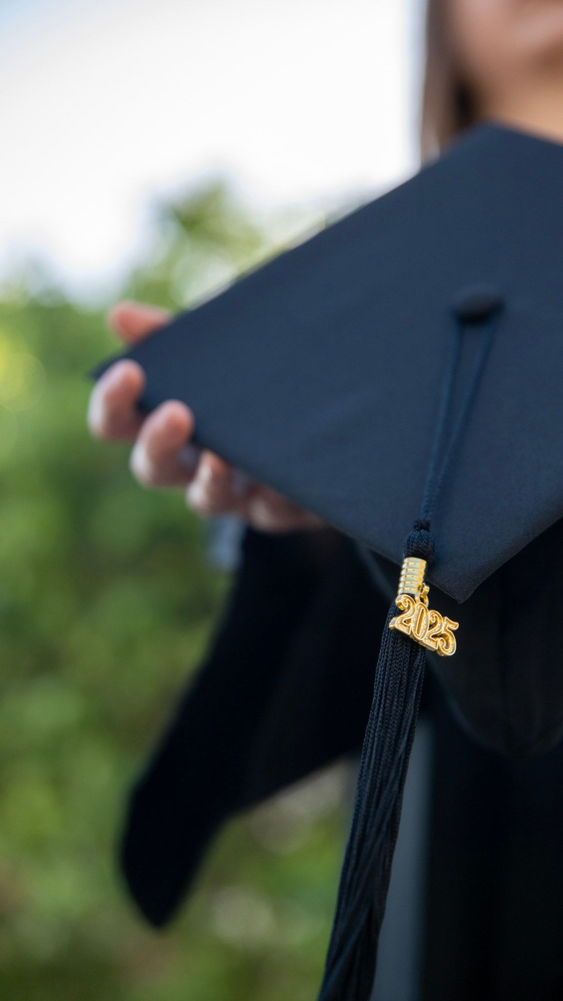 Detail shots of a black graduation cap with gold tassel against blurred background.