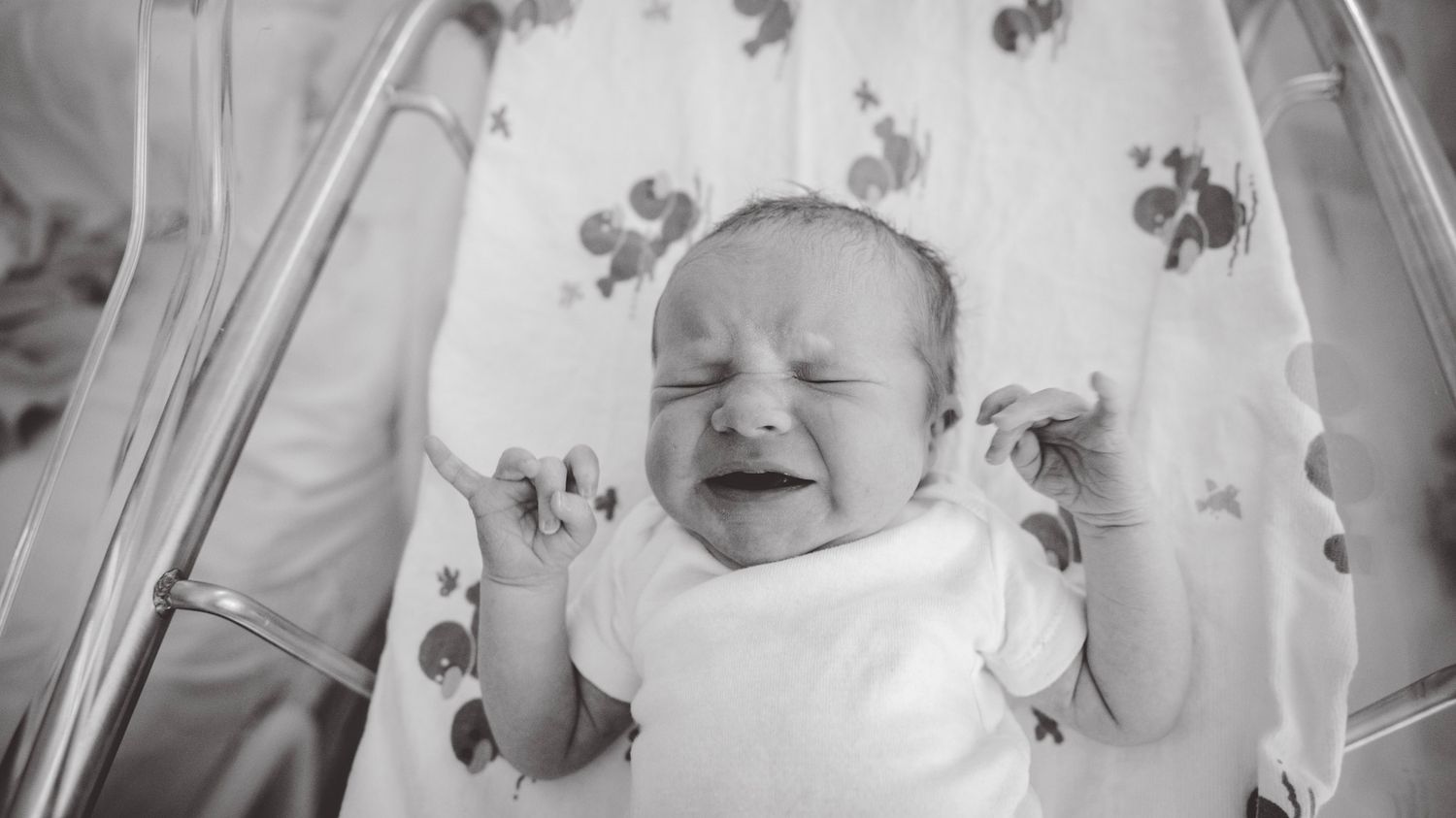 Black and white series of emotional moments with a newborn in the hospital.
