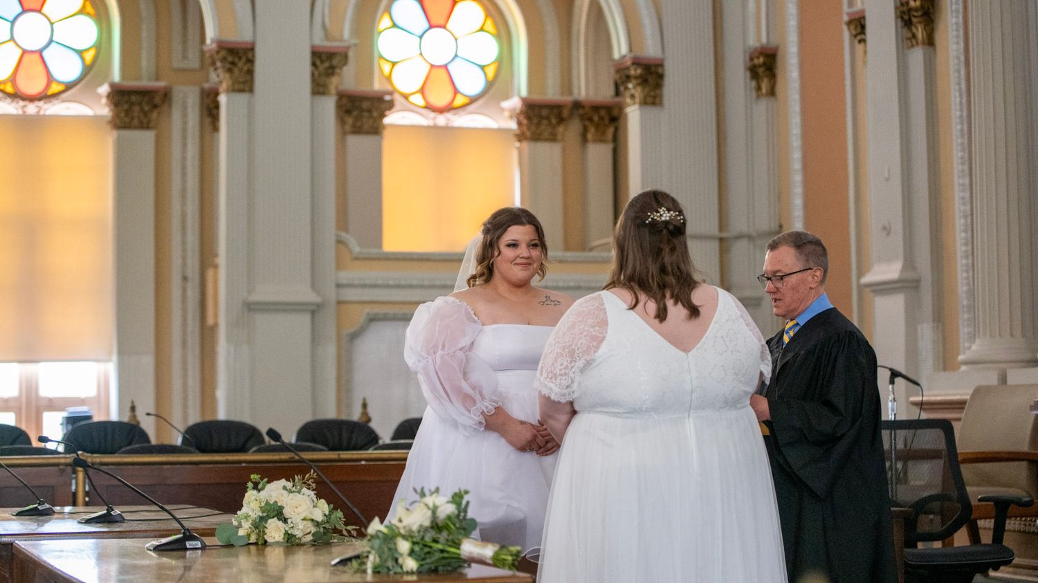 Panoramic view of a wedding ceremony in a traditional church with ornate details.