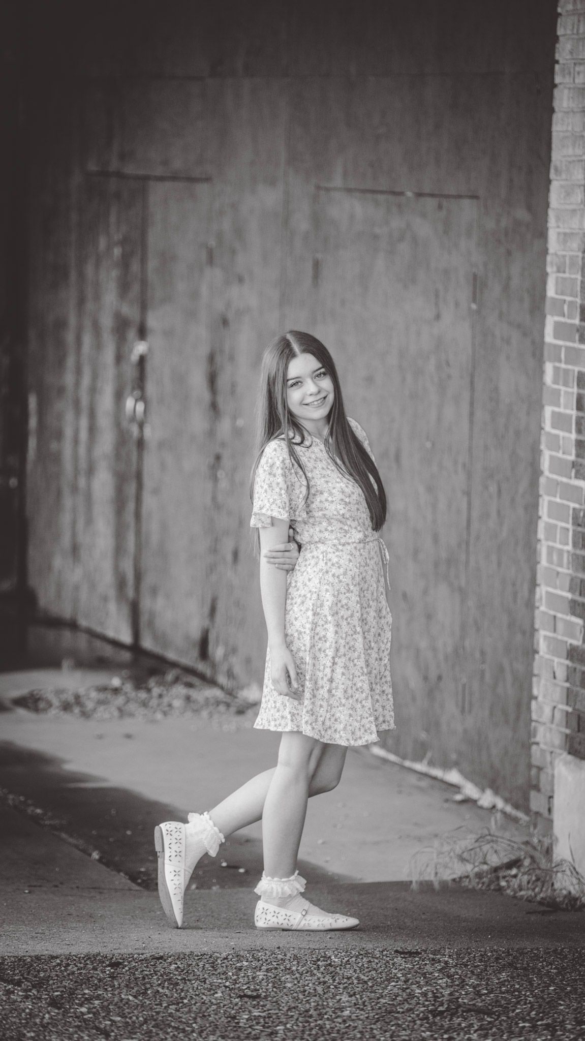 Black and white portrait series against an urban concrete backdrop.