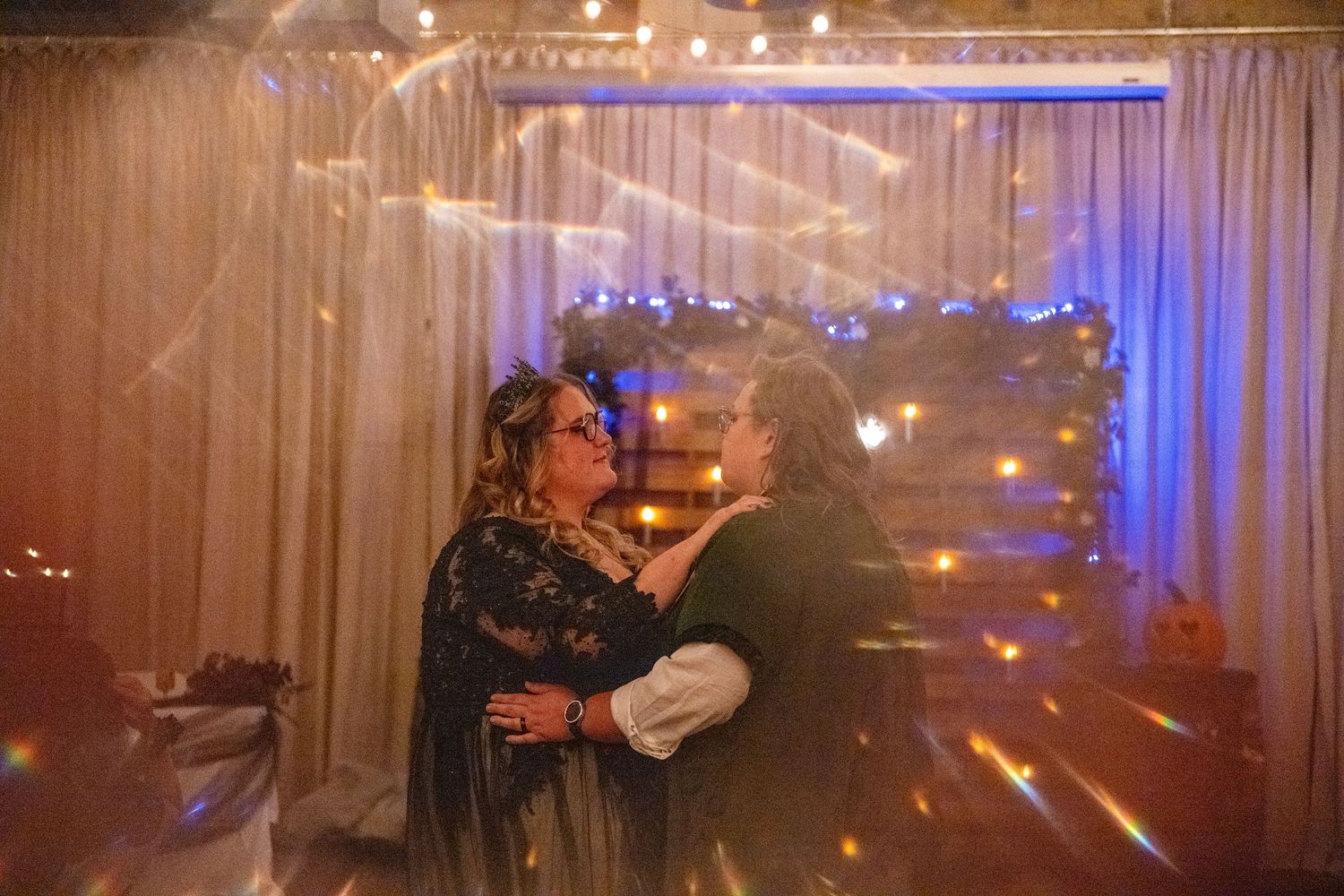 Reception hall with dramatic lighting and fog effects creating a mystical atmosphere.