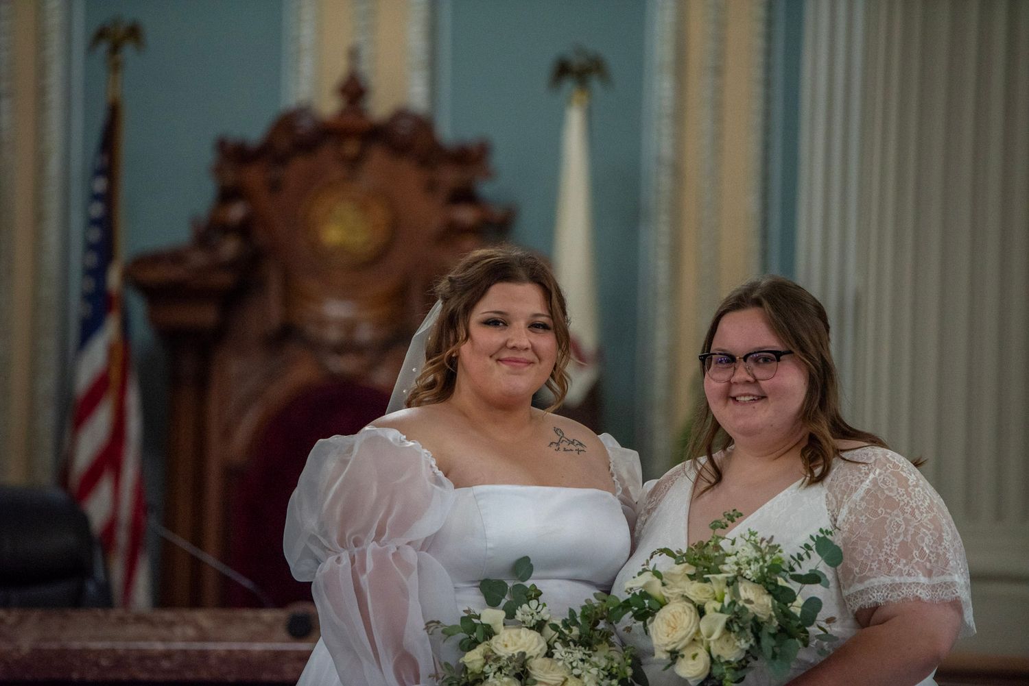 Wedding ceremony in an elegant church with ornate architecture and stained glass windows.