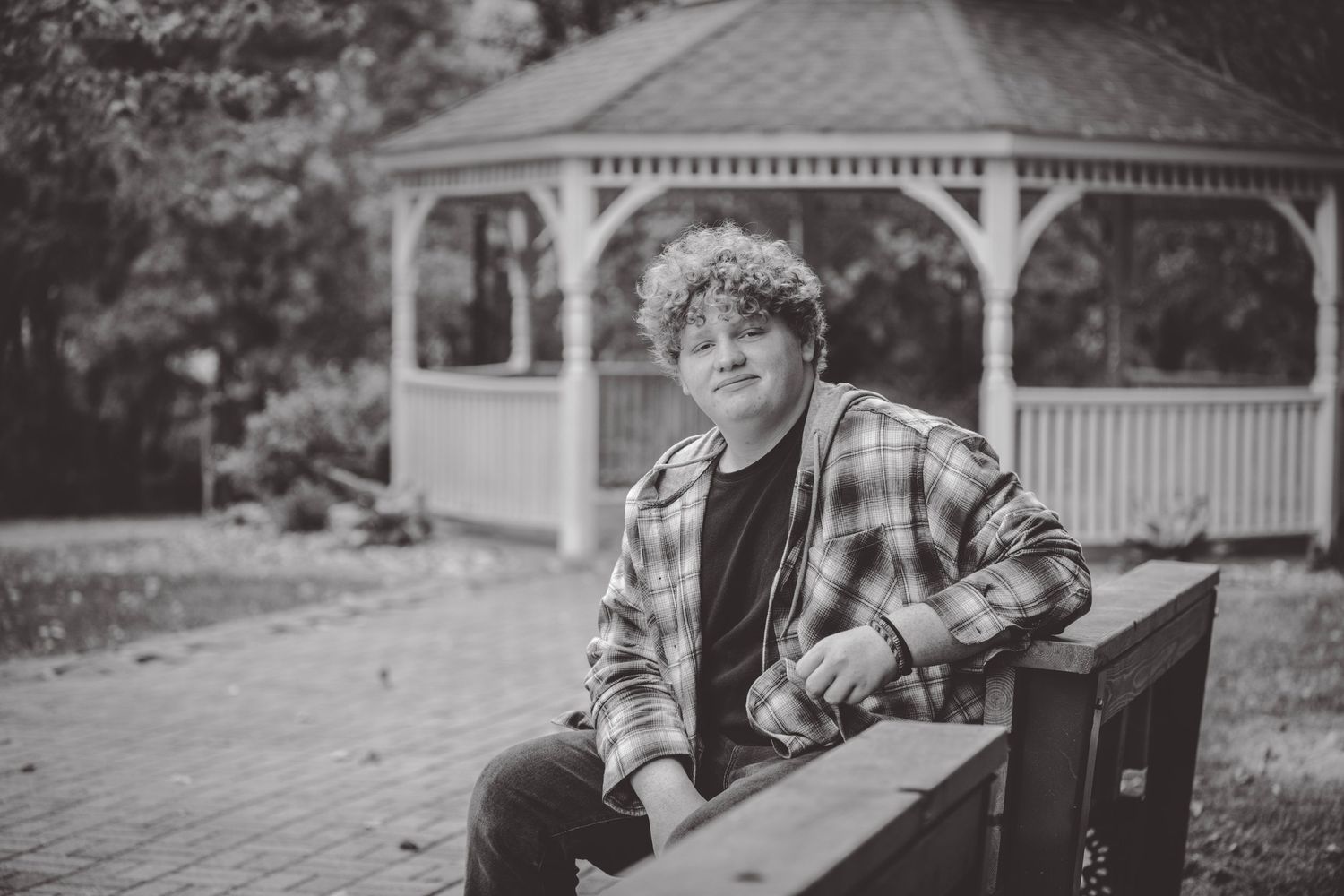 A series of outdoor portrait photos showing a person in a black jacket against a gazebo background.