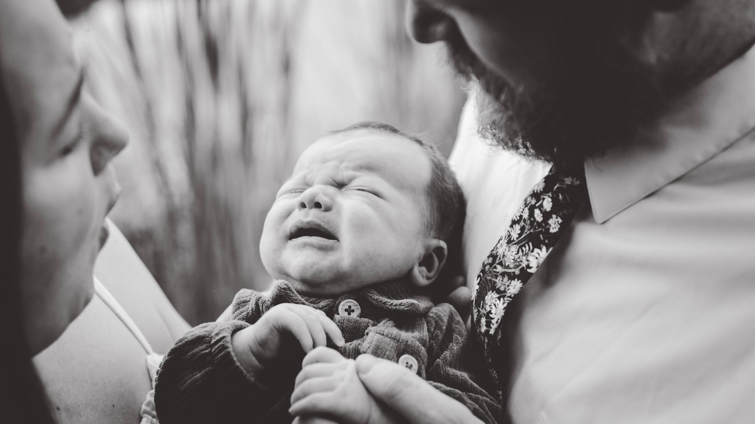 Intimate black and white close-up shots showing tender family interactions.