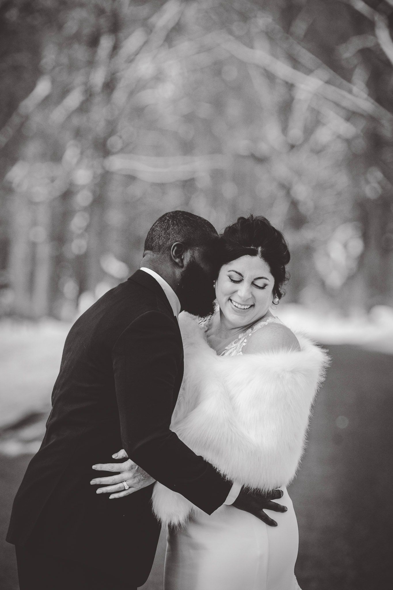 Black and white winter wedding portraits capturing intimate moments in snowy setting.