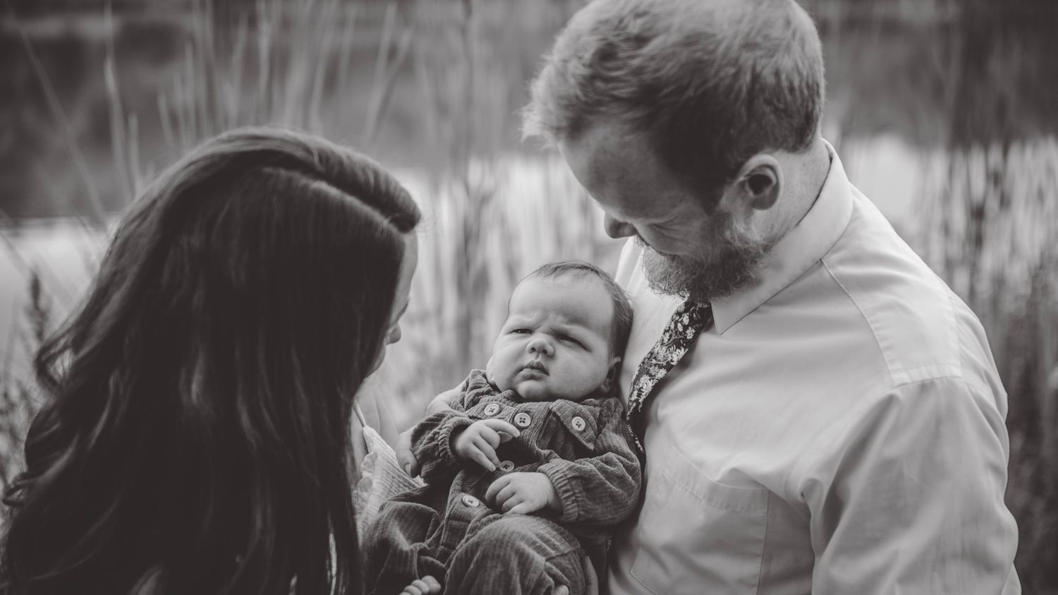 An intimate black and white close-up photograph showing tender family moments.