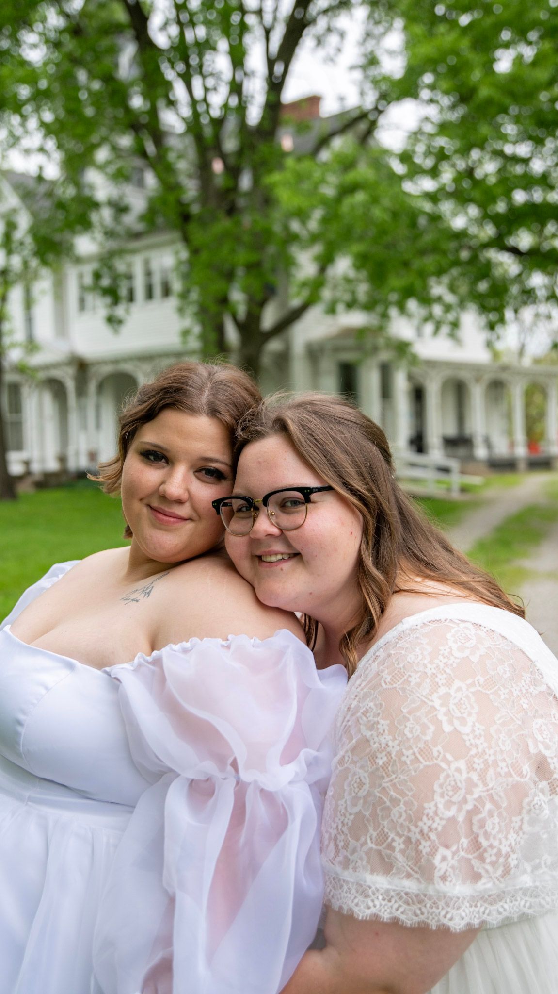 Close-up wedding portraits against lush green spring backdrop.