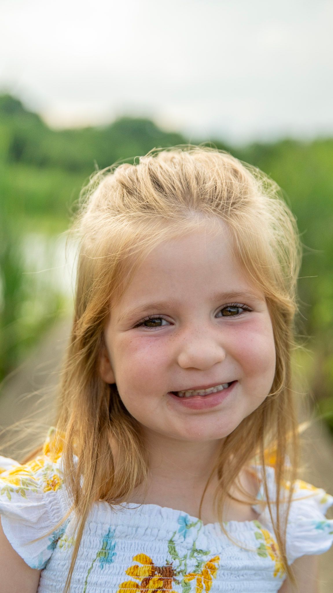 Close up portrait with bright natural lighting and soft expression.
