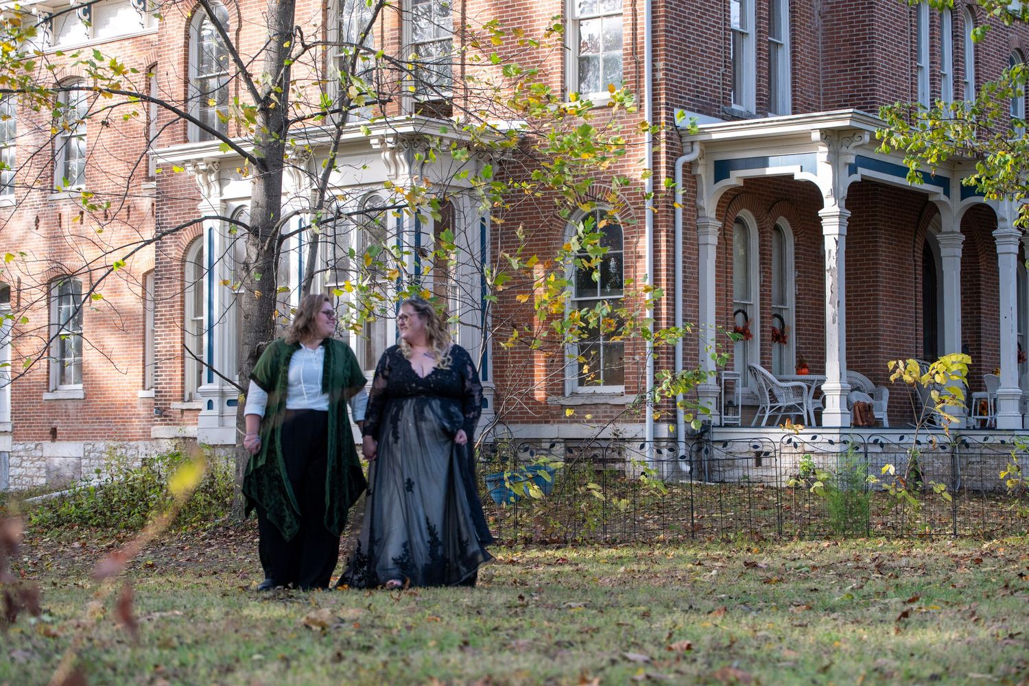 Historic brick building with ornate architecture serves as backdrop for an autumn photoshoot.