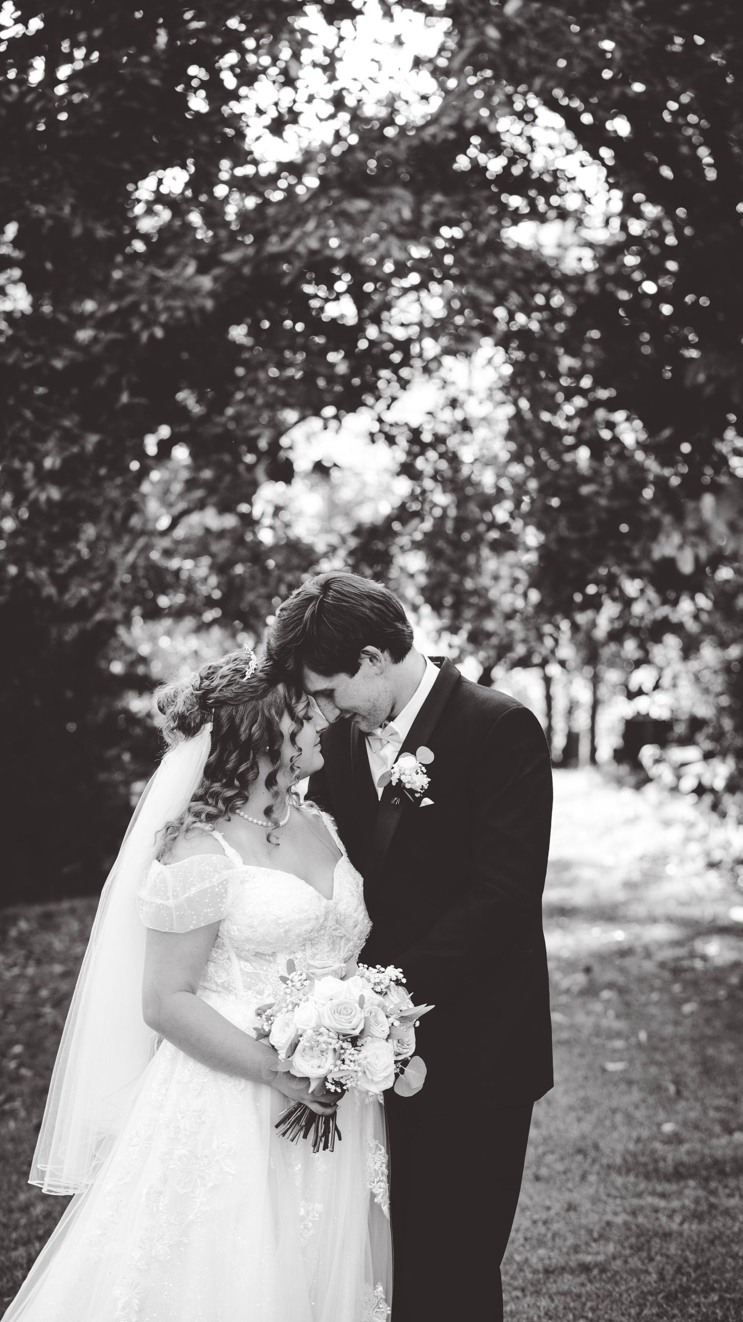 Black and white wedding portraits captured in a natural outdoor setting.