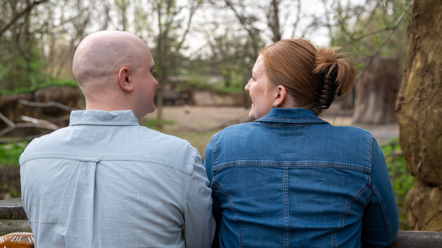 A sequence showing the back view of a couple in casual attire standing close together.
