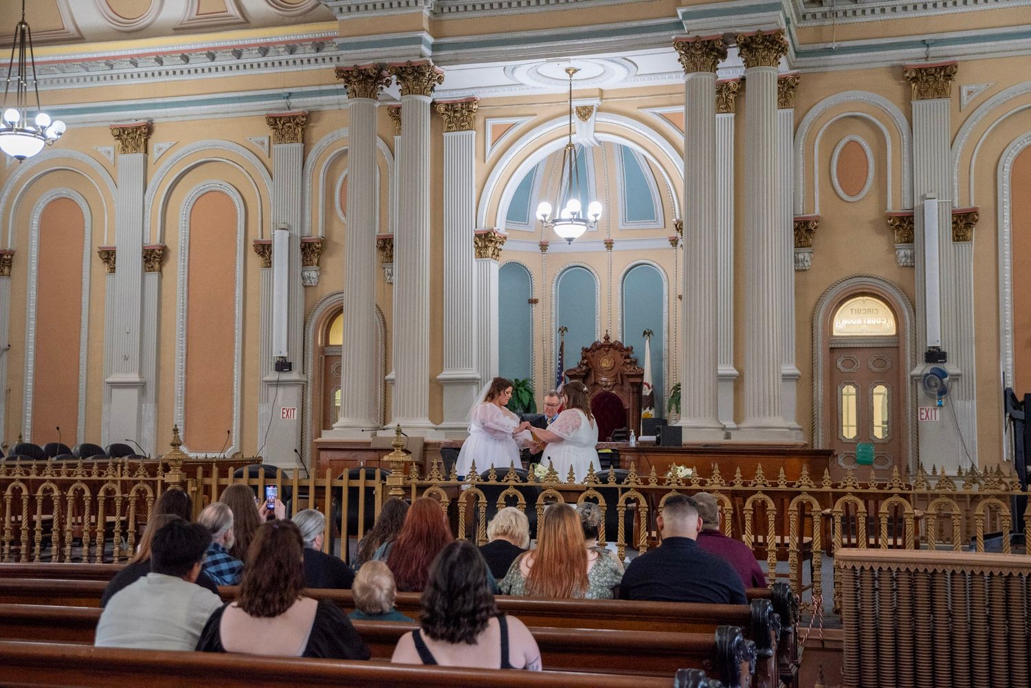 Wide view of a traditional church interior with classical architecture and wooden pews.