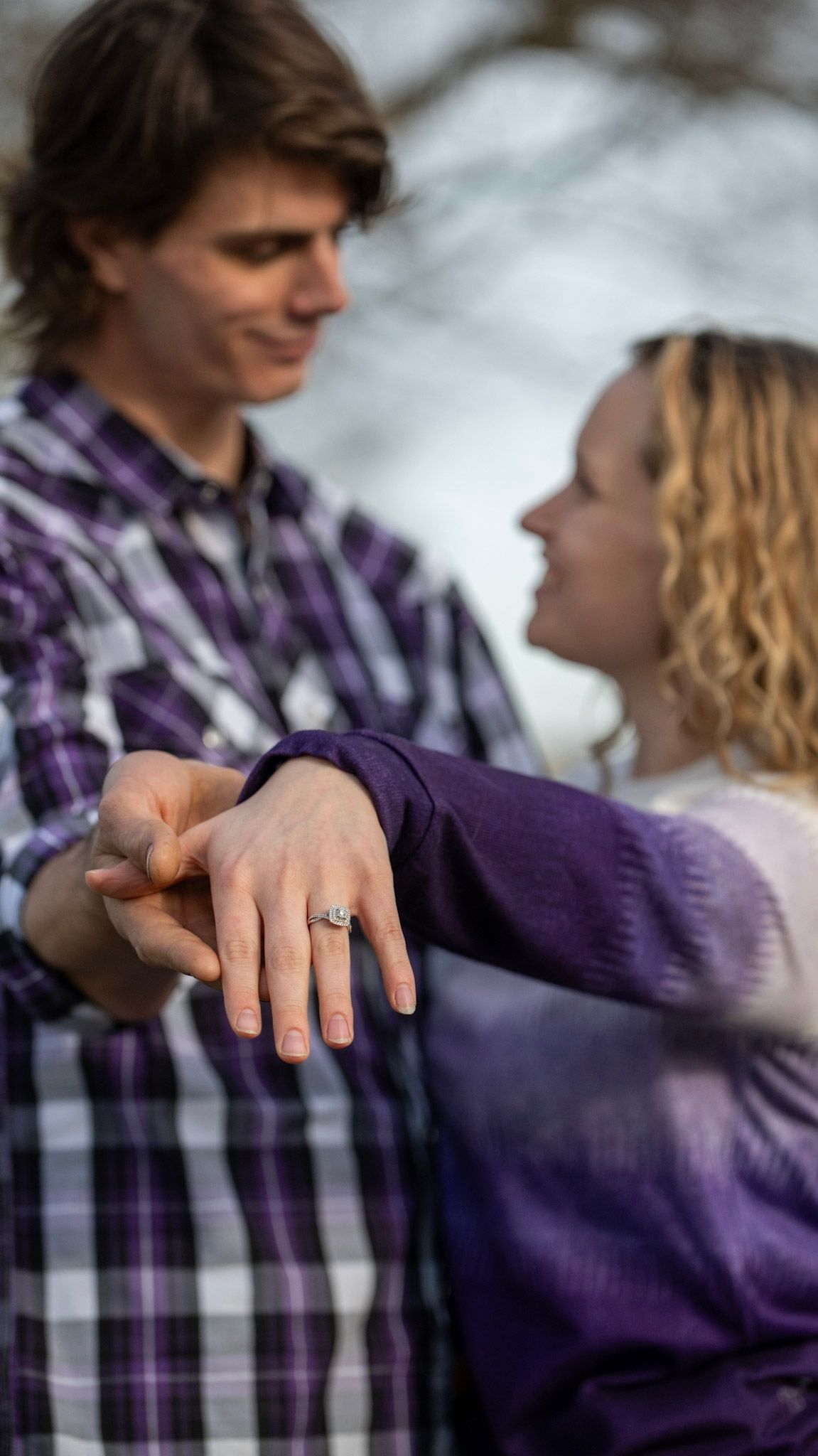 Close-up series showing hands and embraces between a couple wearing purple and plaid.