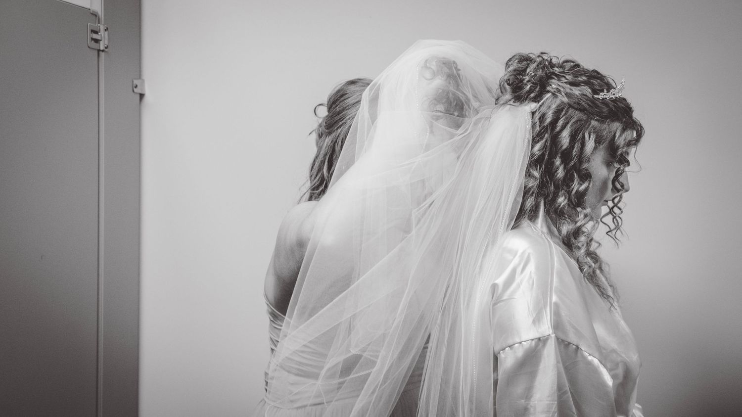 Artistic black and white wedding photography showing flowing veil movement.