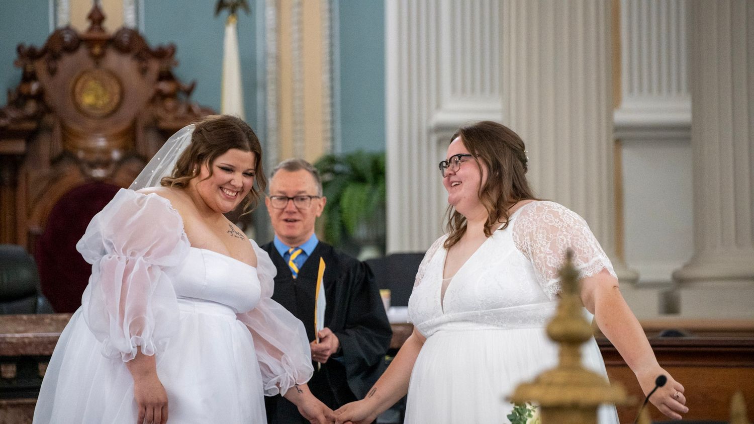 Panoramic view of courthouse wedding ceremony with elegant architectural details.