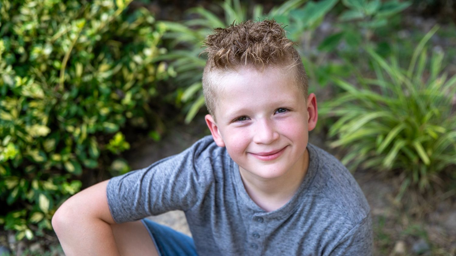 Close-up outdoor portraits showing joyful expressions against natural garden background.