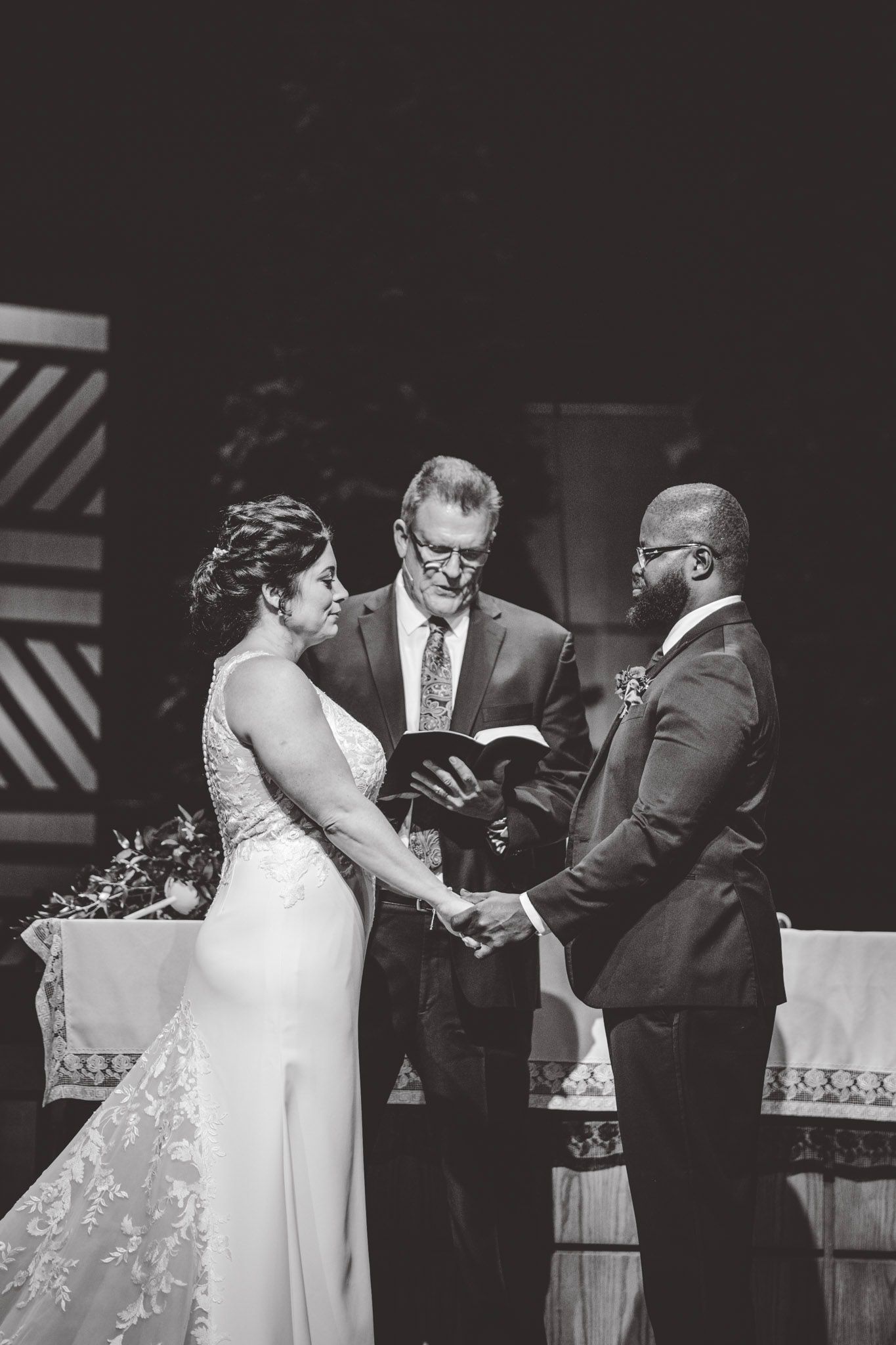 Black and white sequence of wedding ceremony with couple exchanging vows.