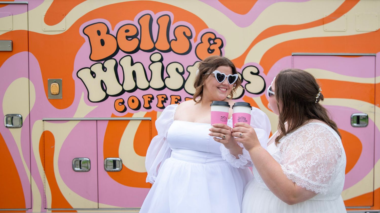 Colorful orange and pink Dunkin Donuts storefront signage with retro swirl design.