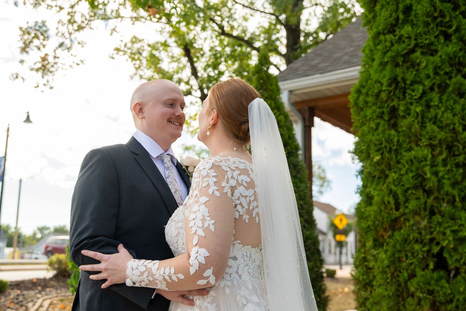 A wedding couple shares intimate moments in front of a church and outdoors, captured in a series of romantic poses.
