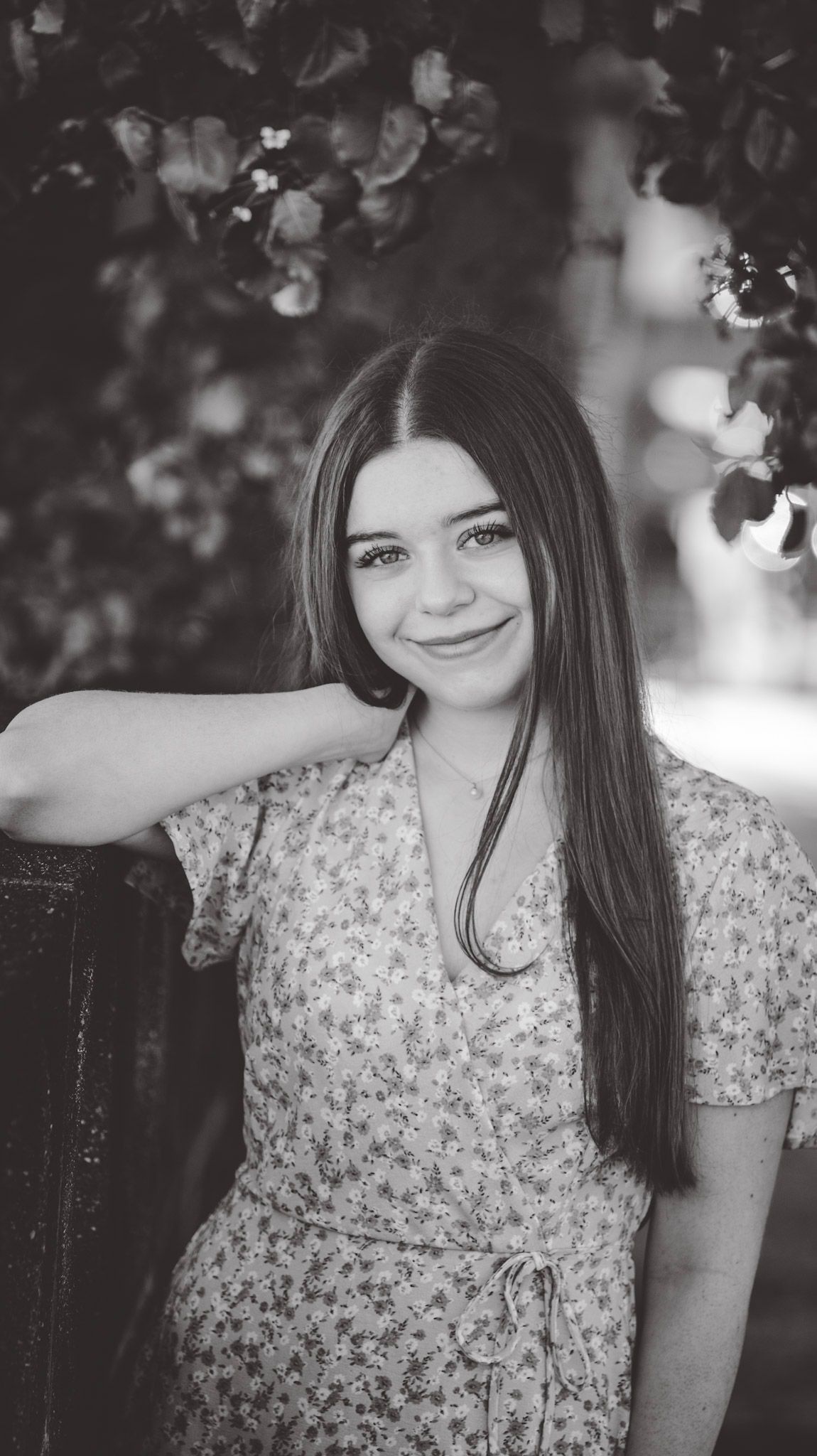 Black and white portraits in a floral dress with artistic bokeh effects.