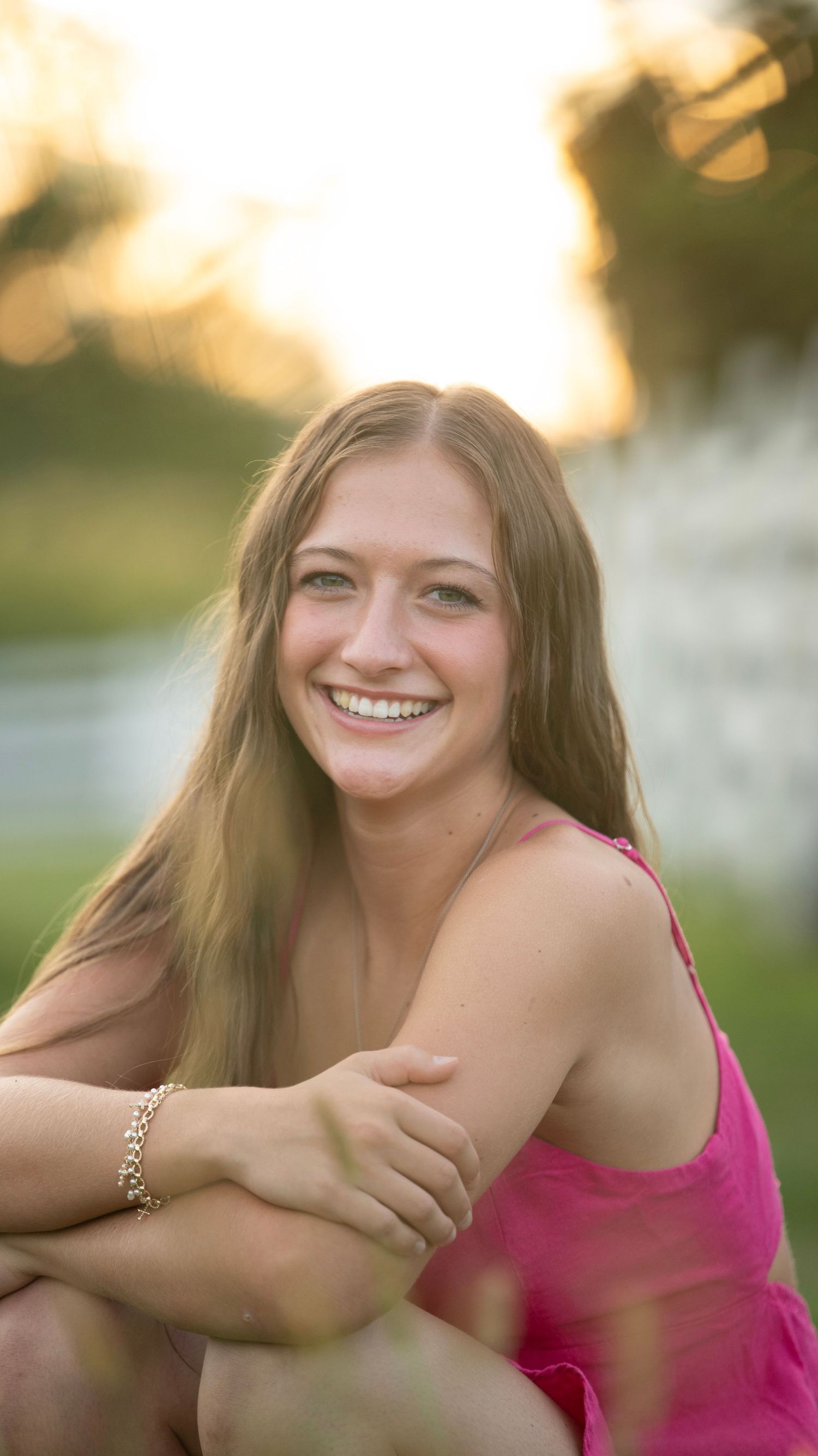 Soft golden hour portrait with natural smiles and warm backlighting.