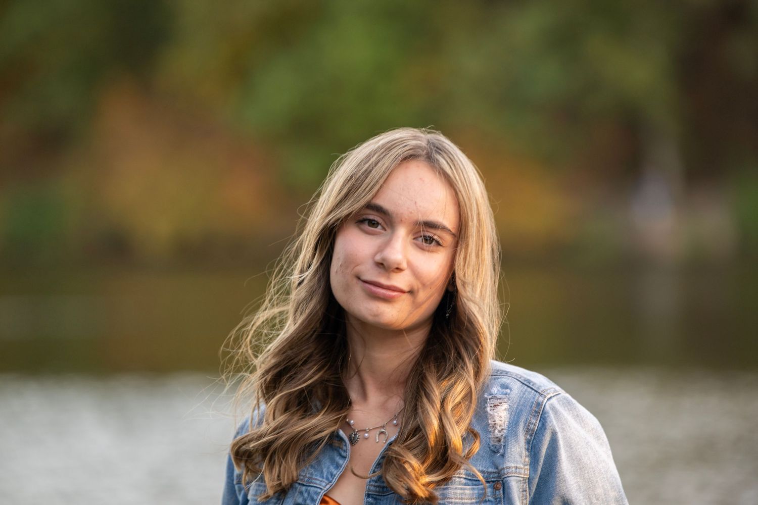 Outdoor portrait series with natural lighting and autumn foliage in the background.