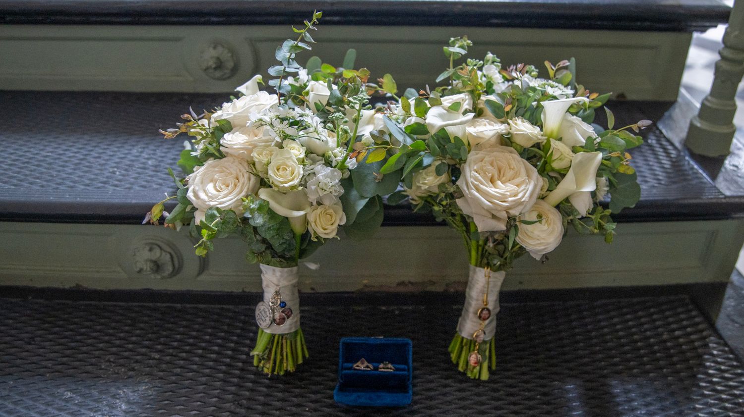 Wedding bouquets and floral arrangements displayed against a dark background.