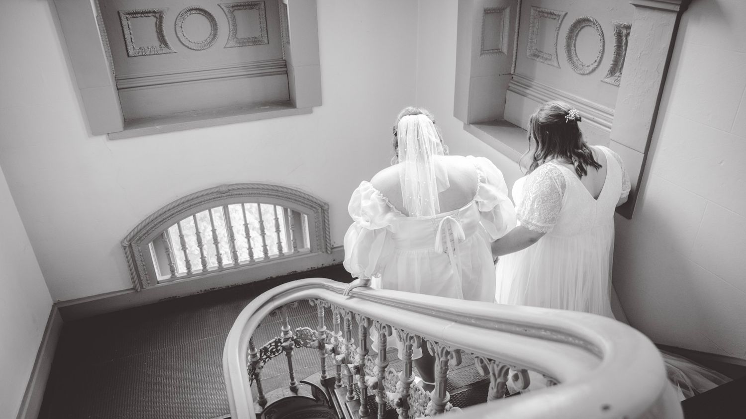 Panoramic view showing white dress details in an ornate interior setting.