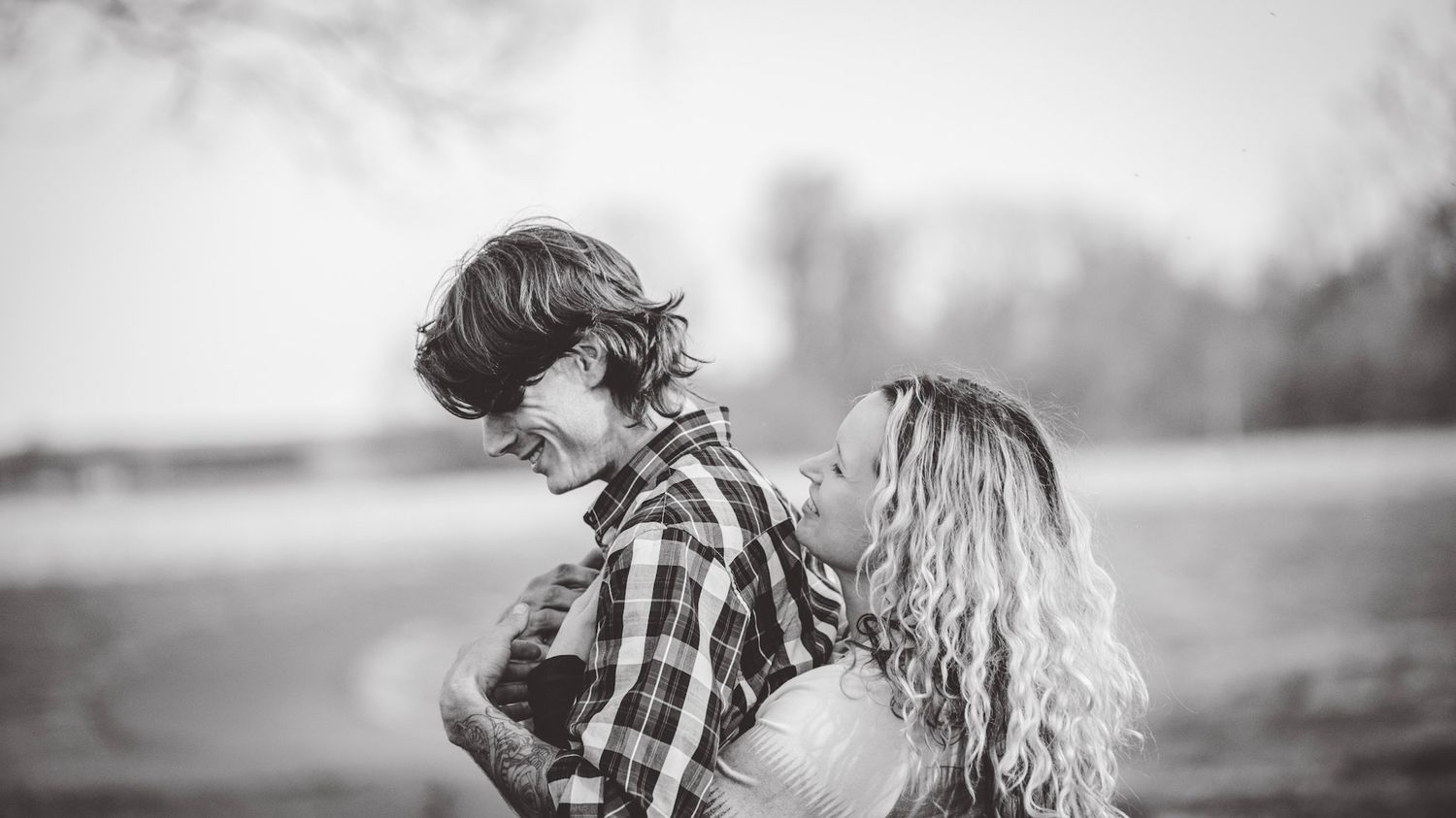 Black and white panoramic series of a couple's romantic moments outdoors.
