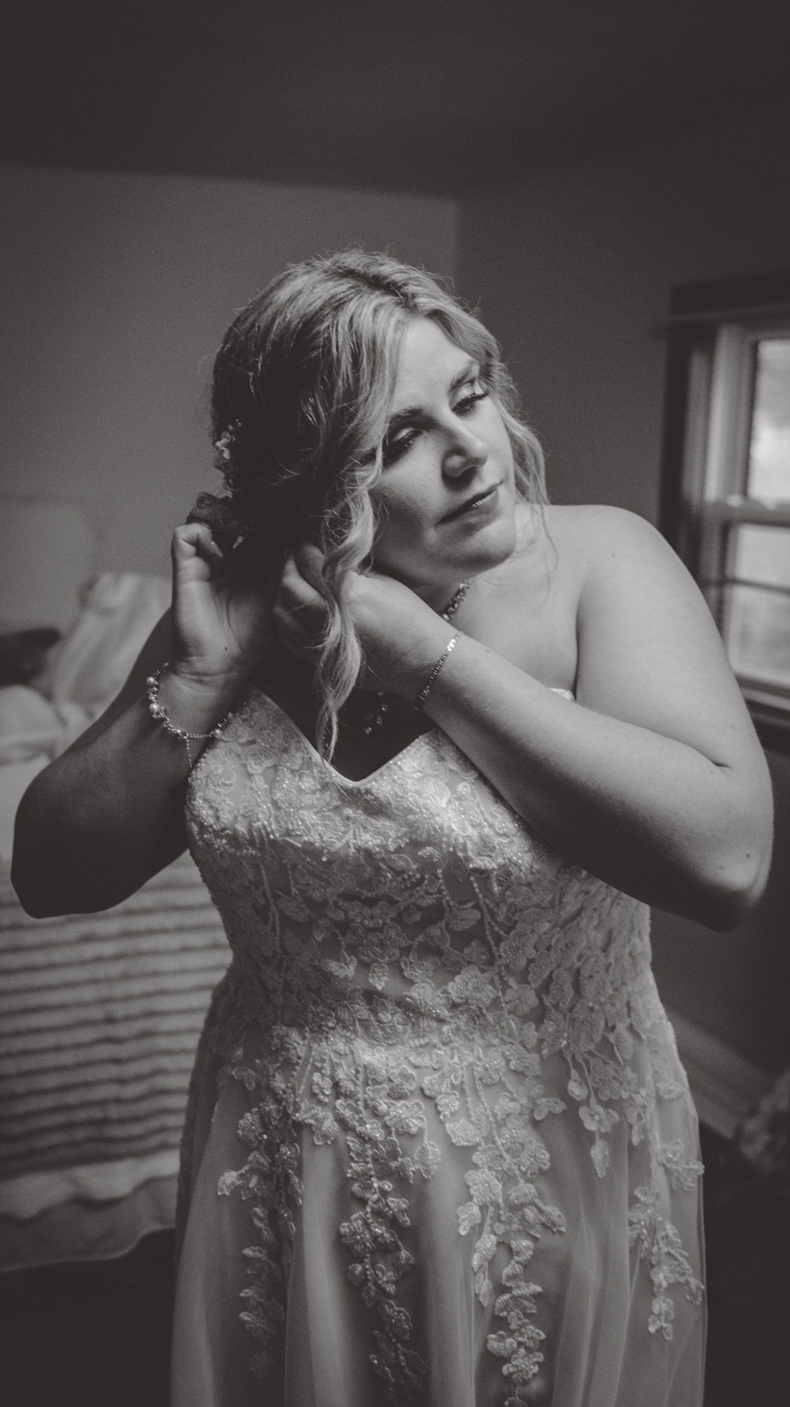 Black and white portrait showing intricate details of a lace wedding dress.