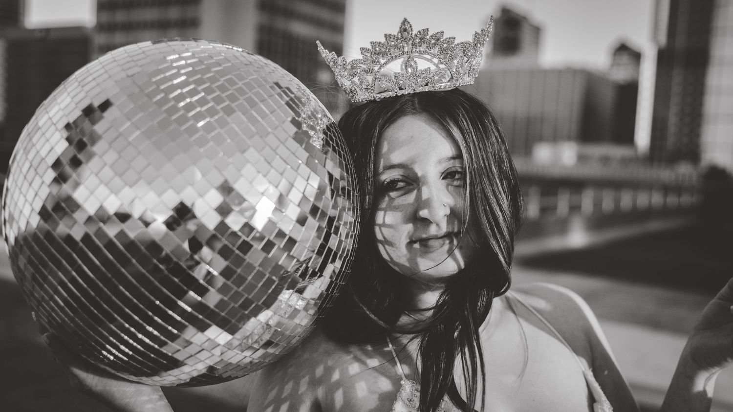 An artistic black and white panoramic fashion portrait series with disco ball props.