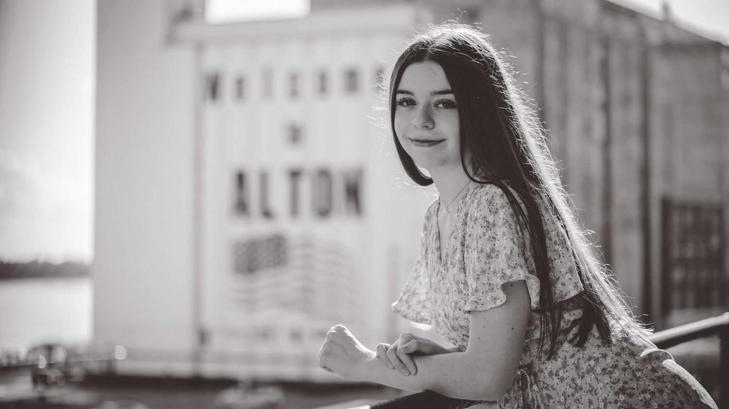 Black and white portraits showing someone in casual attire against an urban backdrop.