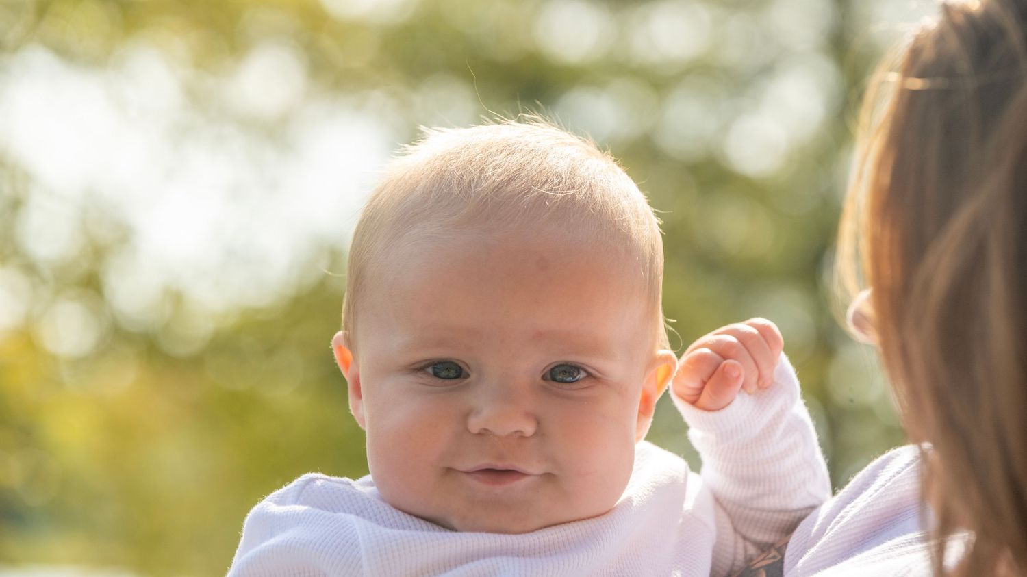 Candid outdoor family moments captured in warm autumn lighting.