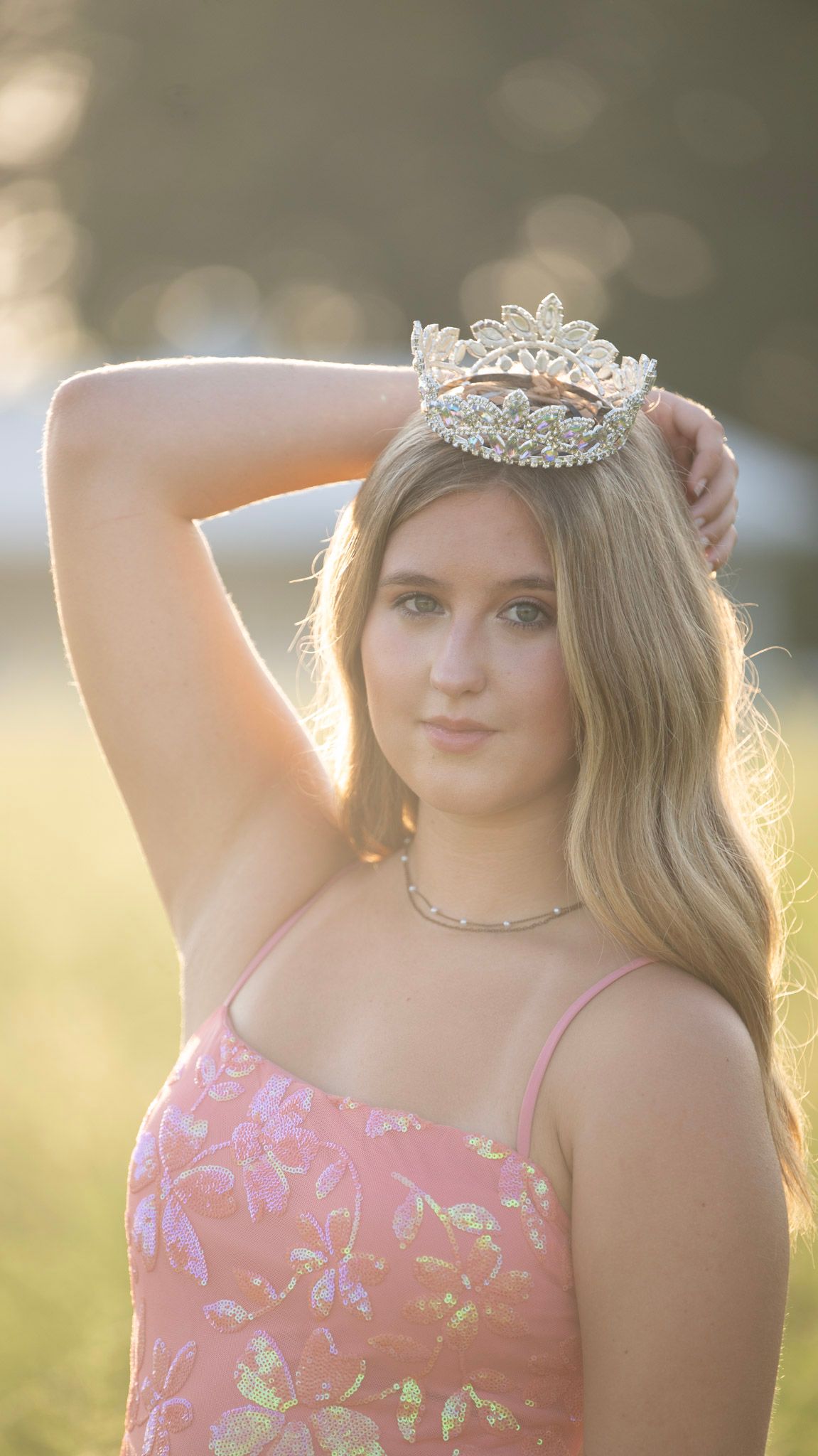 A sparkly lavender formal dress and tiara captured in golden sunset lighting.