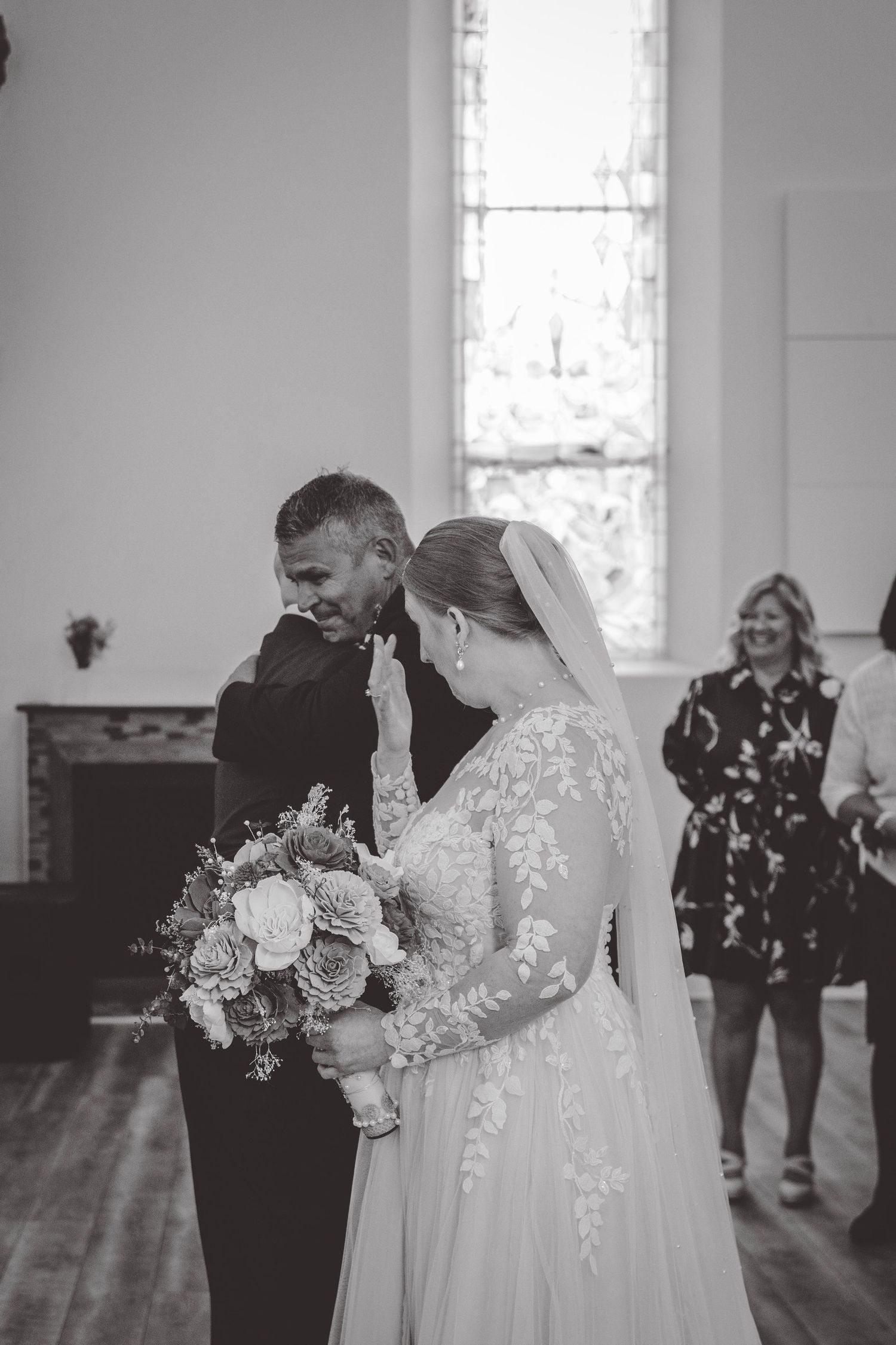 Black and white wedding ceremony photos showing intimate moments in church.