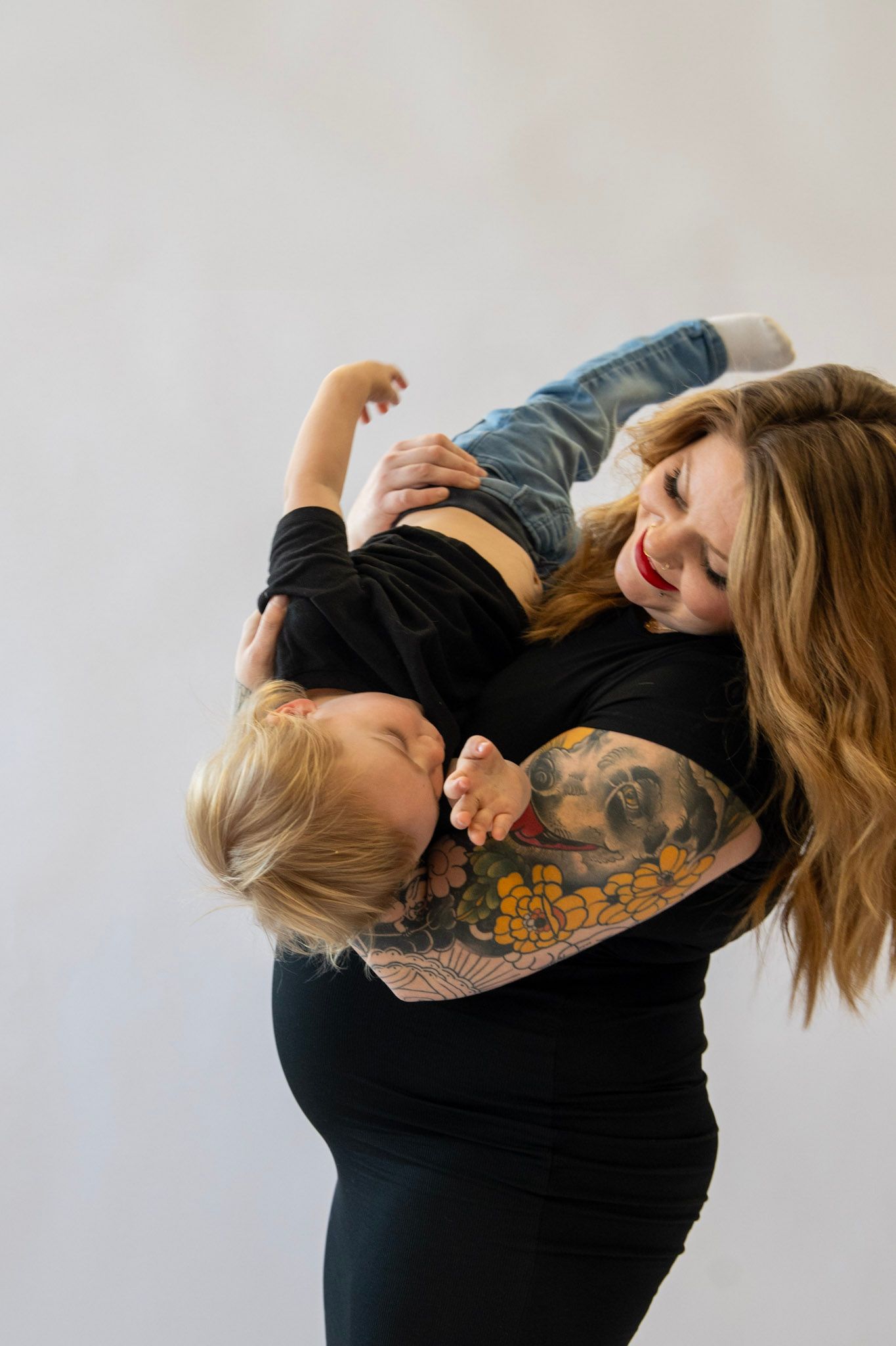 Mother and child sharing tender moments during maternity photo session.