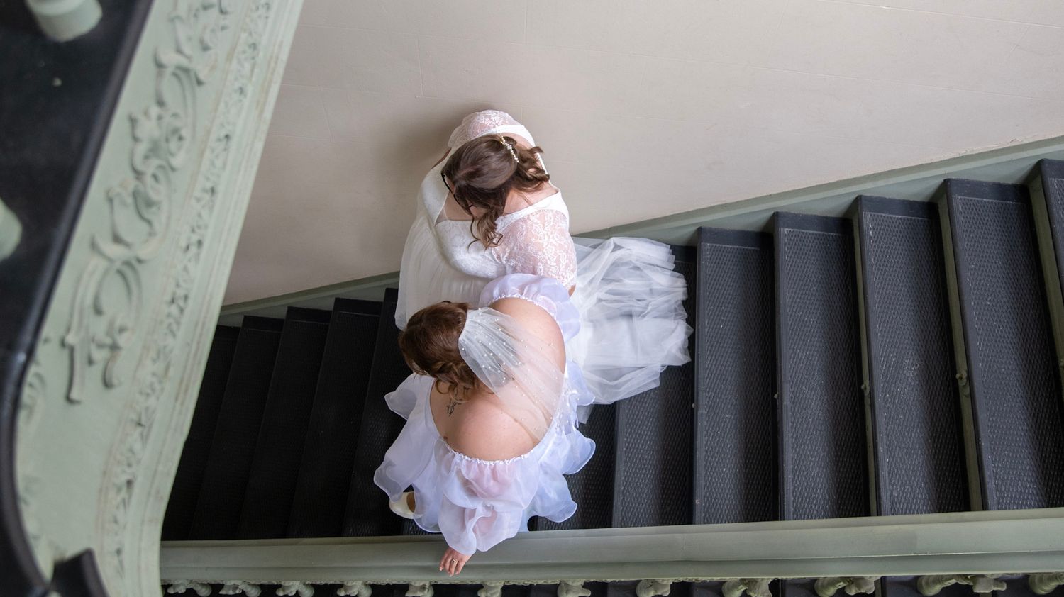 Wedding photography sequence captured on an elegant staircase with decorative railings.