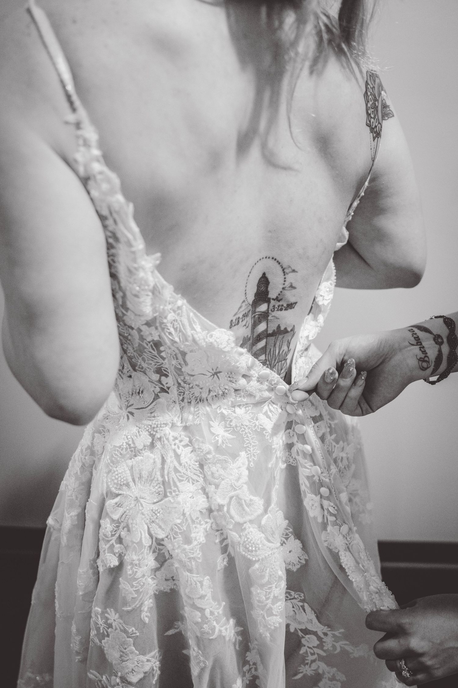 Close-up details of delicate lace work on a white wedding dress.