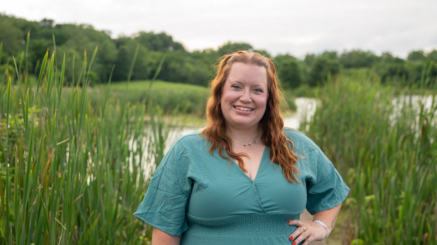 Scenic path through tall grass and cattails on a summer day.