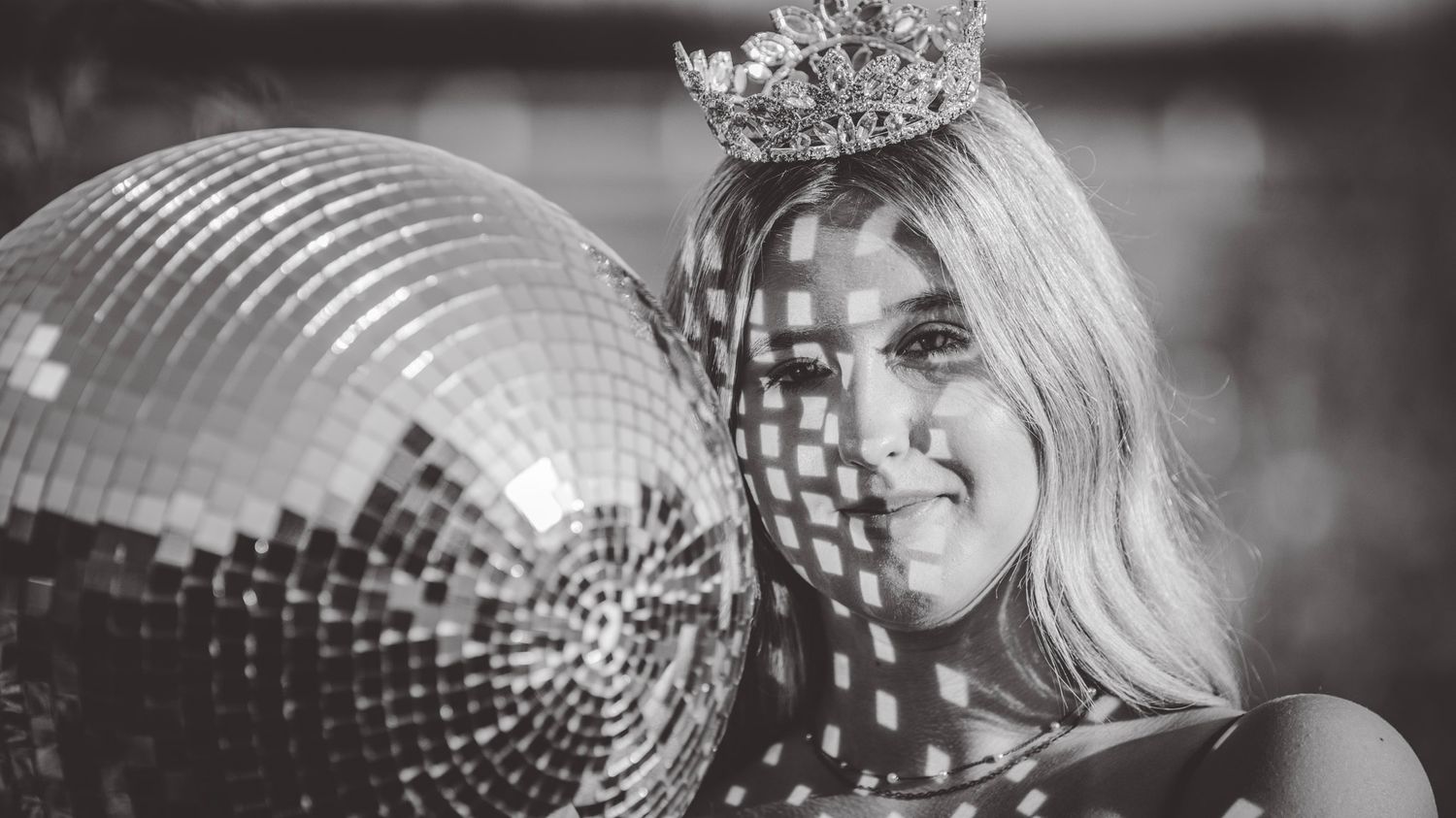 Black and white artistic portrait with sparkly accessories and dramatic lighting.