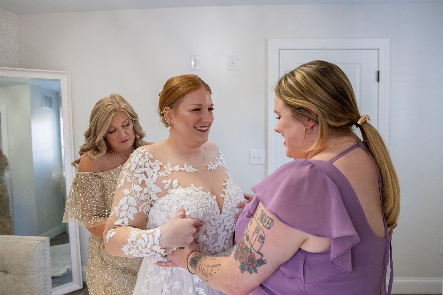 Wedding preparation scene showing dress details and final adjustments.