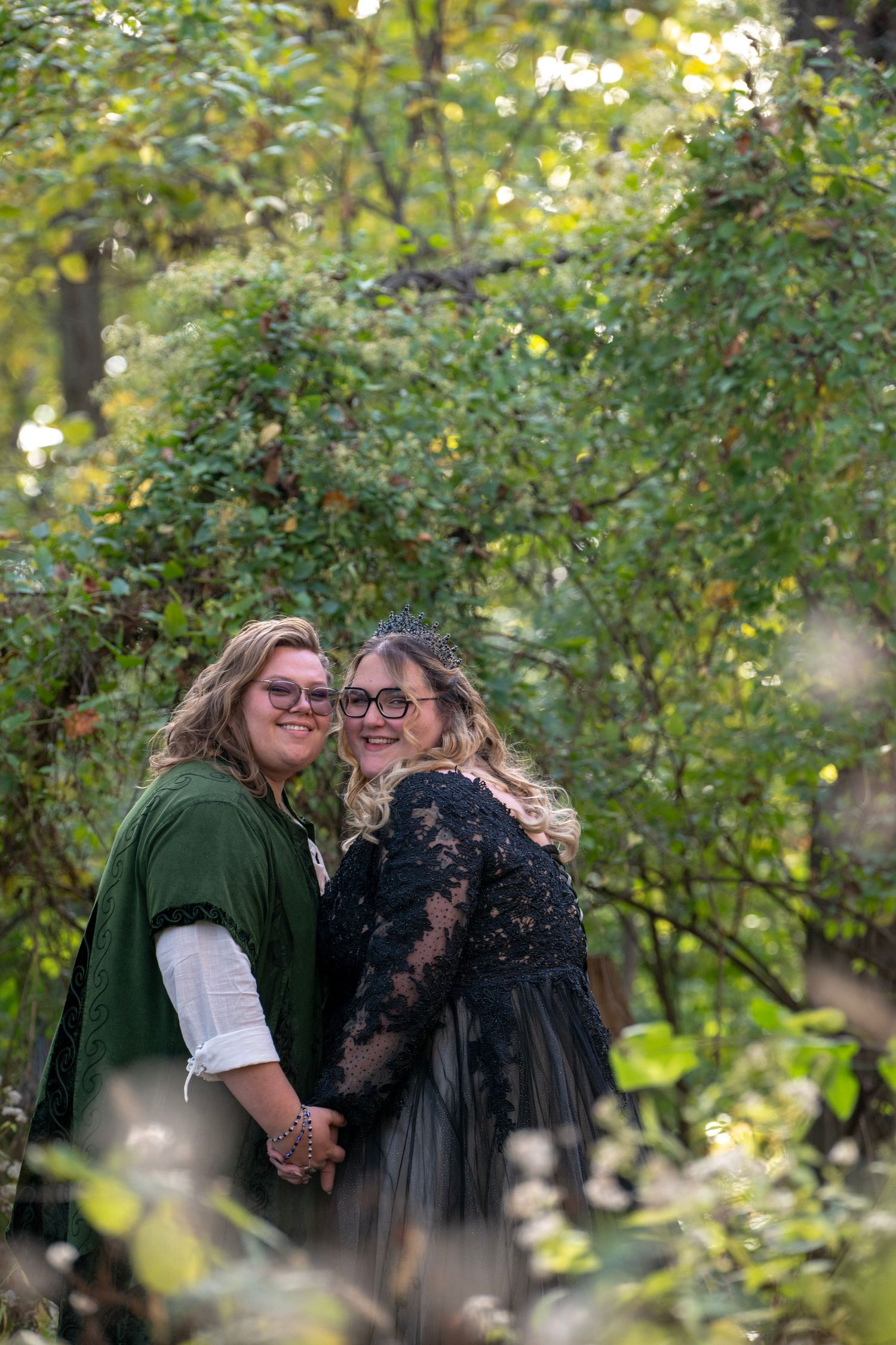 Romantic outdoor photoshoot among autumn foliage with soft natural lighting.