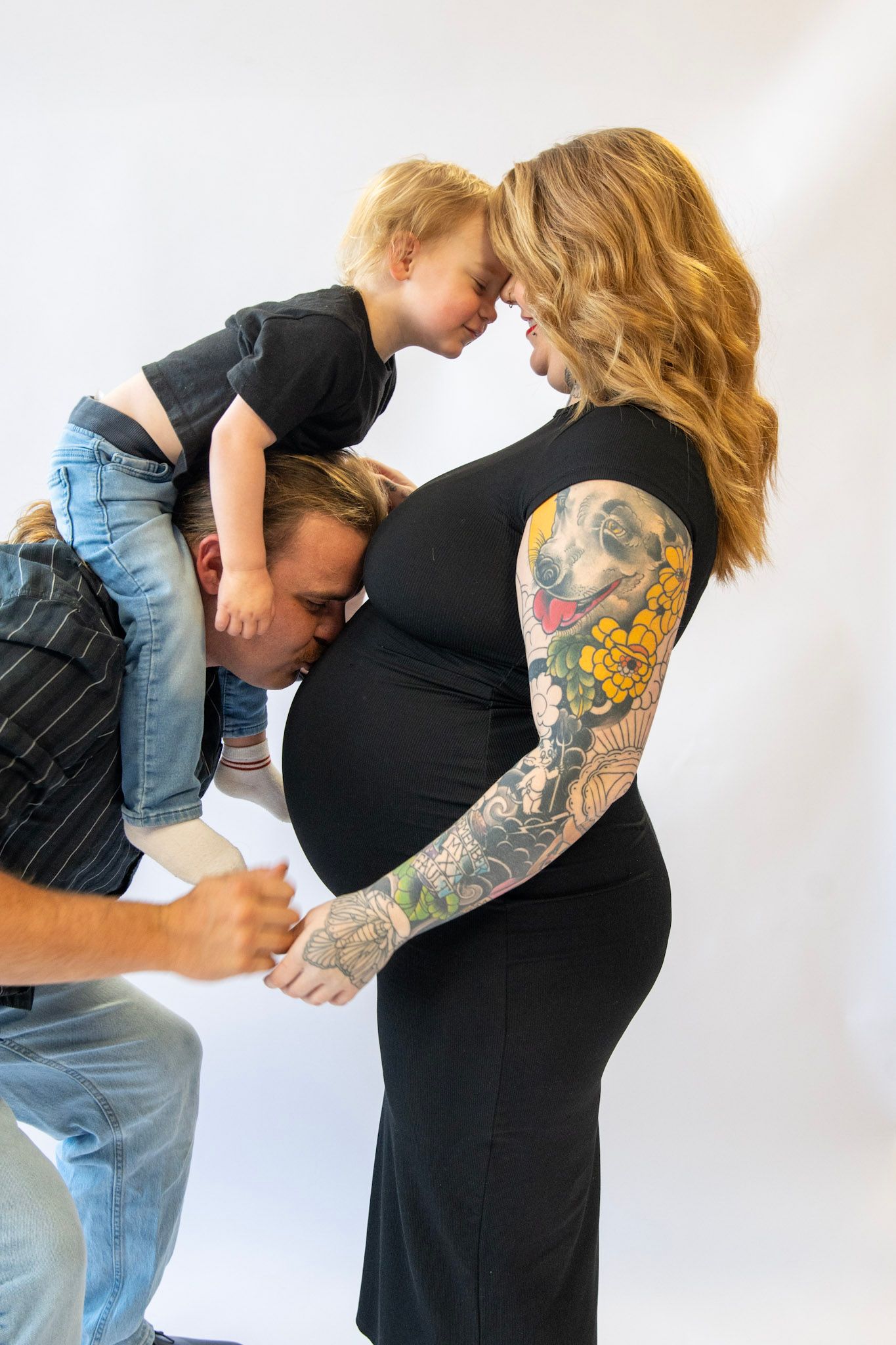 Candid moments between parent and child during maternity photoshoot.